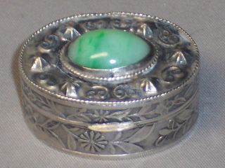   STERLING SILVER AND JADE HINGED PILL BOX WITH RAISED ENGRAVING   CHINA