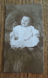 REAL LIFE PHOTO POST CARD OF BABY SITTING ON FUR COAT ( ROARING 20S 