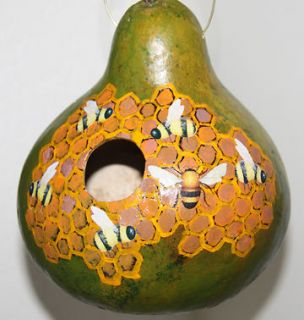 gourd birdhouse with beehive and bees