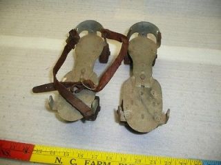 vintage metal roller skates with leather strap antique