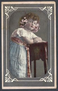 e015 little girl leaning on a desk vintage postcard