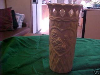 white ceramic vase has roses wicker cut out dimmon cut