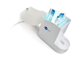 UV Chamber with Three Toothbrush Heads and UV Light Illuminated