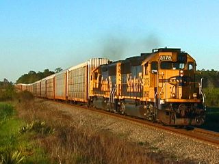 BNSF GP50s #3178 and #3176 lead fast moving southbound CSXT autorack 