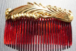  an unopened box of these very impressive gold decorated hair combs