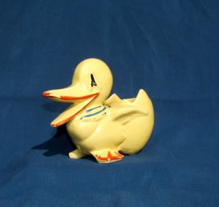 Adorable vintage planter is a baby duck with a blue ribbon around his
