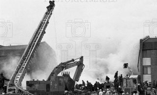  Downers Grove, IL. Firemen and other workers remove a body from the