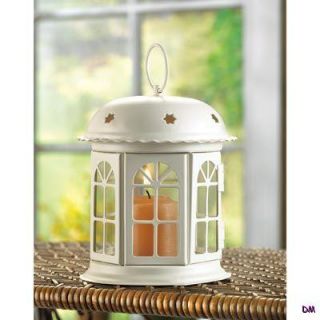 Gracious miniature gazebo lantern shines with golden light through its