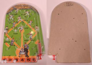 This is a vintage 1960s baseball pinball hand held game. It made of