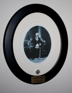  to the frame is an engraved plaque that reads President GEORGE