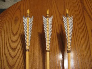 ONE DOZEN PRIMITIVE ARROWS WITH ARTIFICIAL BARRED FEATHERS