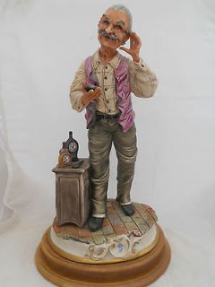 Capodimonte figurine of a man with clocks / watch signed J C Gianetto