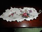 Leaf shaped hand painted, porcelain trinket dish [ with crossed arrows